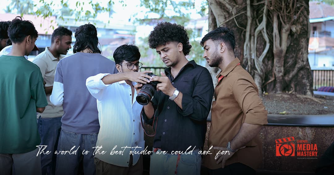 Students reviewing shots during an outdoor photography session at Legends Media Mastery