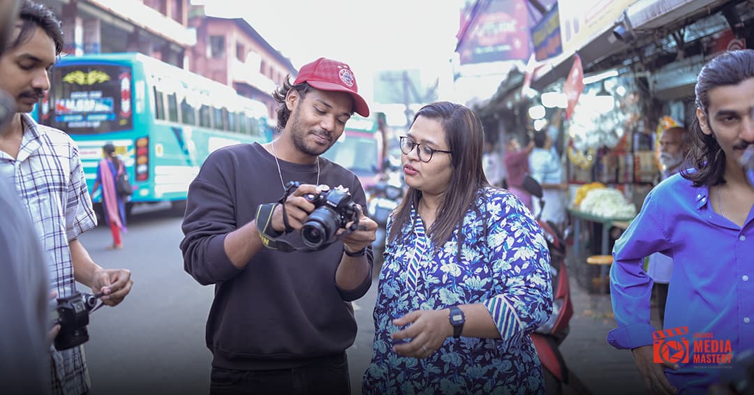 Students learning street photography in a busy Kerala market with mentor guidance