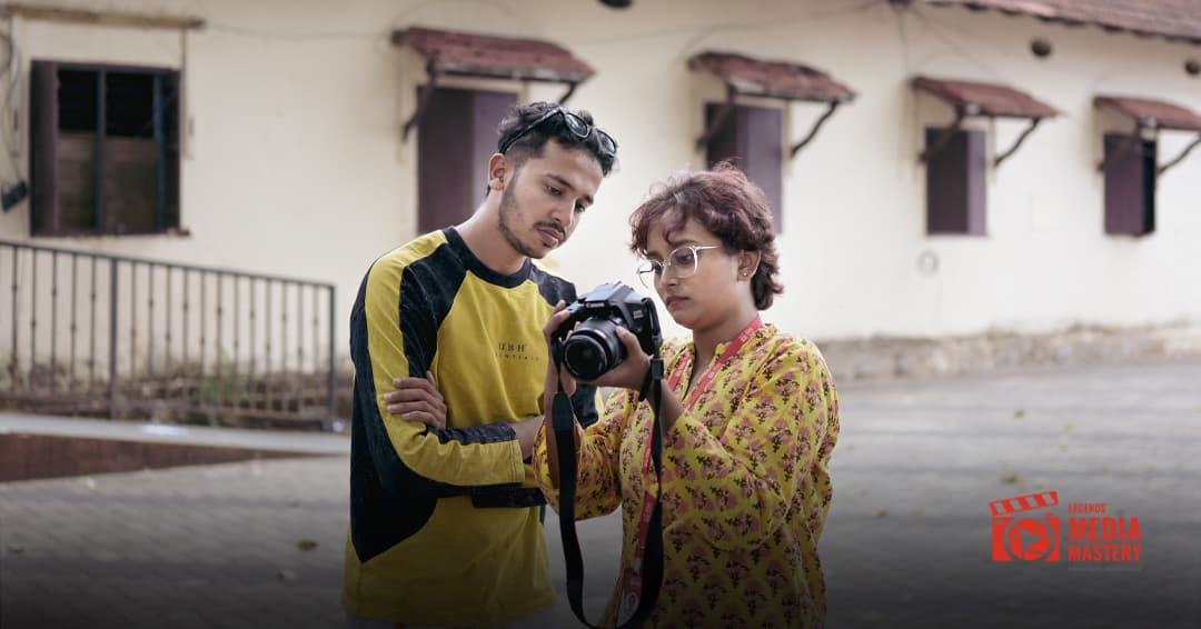 Mentor guiding student with DSLR camera during a practical photography session